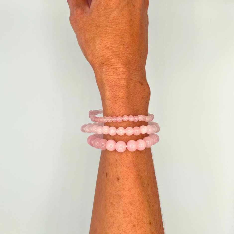 Three Rose Quartz Bracelets on a Wrist
