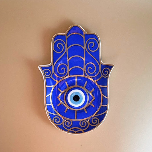 Bring the power of protection and ancient symbolism to your home with the Golden Pharaoh Evil Eye Protection Trinket Tray.